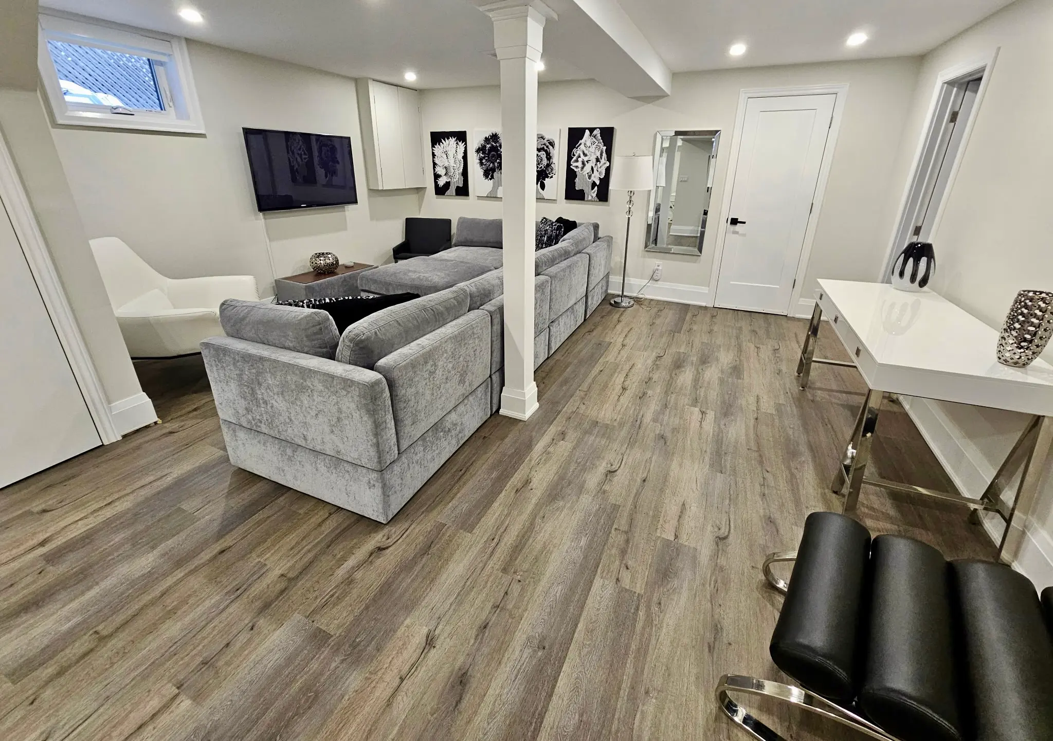 Finished basement with grey luxury vinyl plank