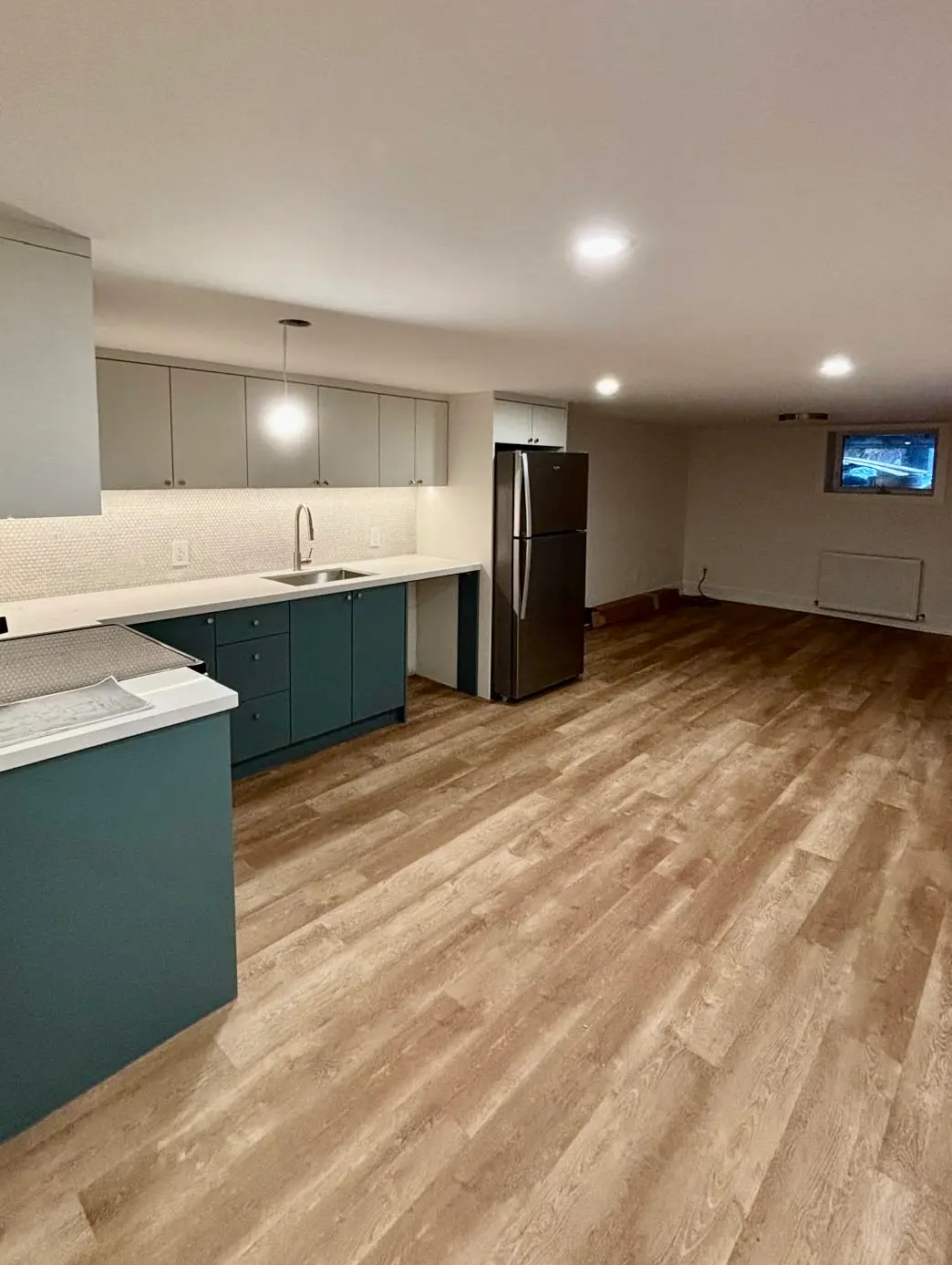 Basement kitchenette with warm LVP flooring