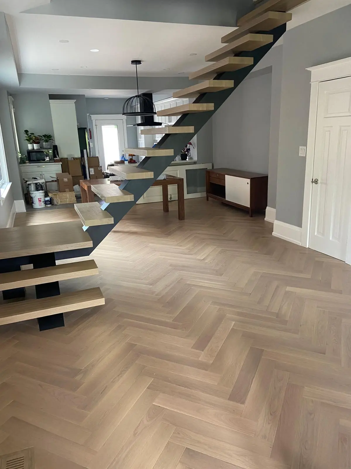 Herringbone flooring with floating staircase
