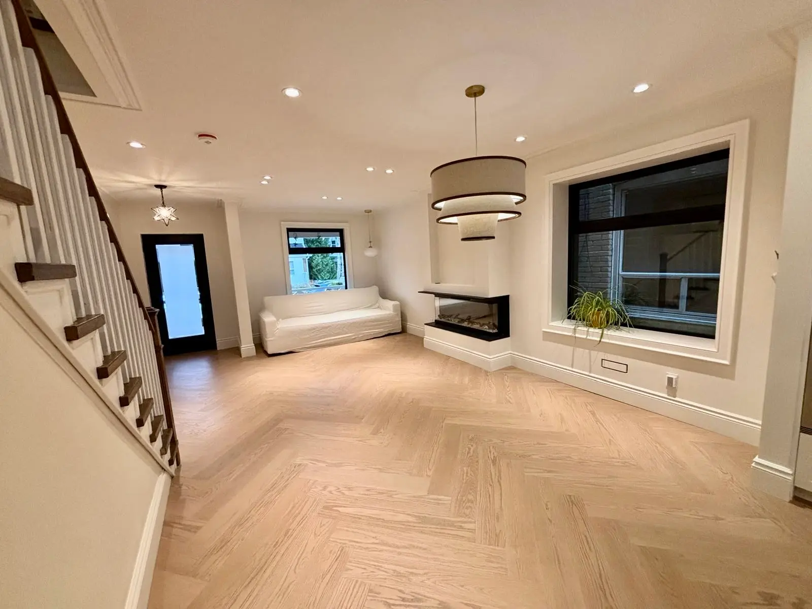 Herringbone hardwood living room with pendant lights