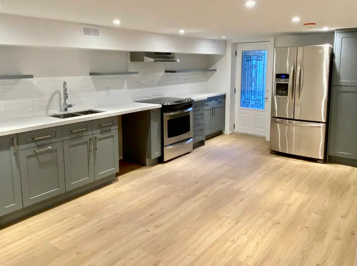 Kitchen with grey cabinets and light LVP