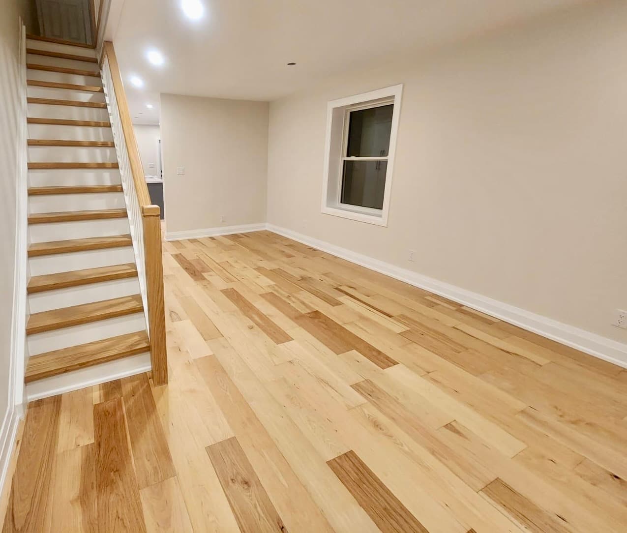 Light maple hardwood with staircase