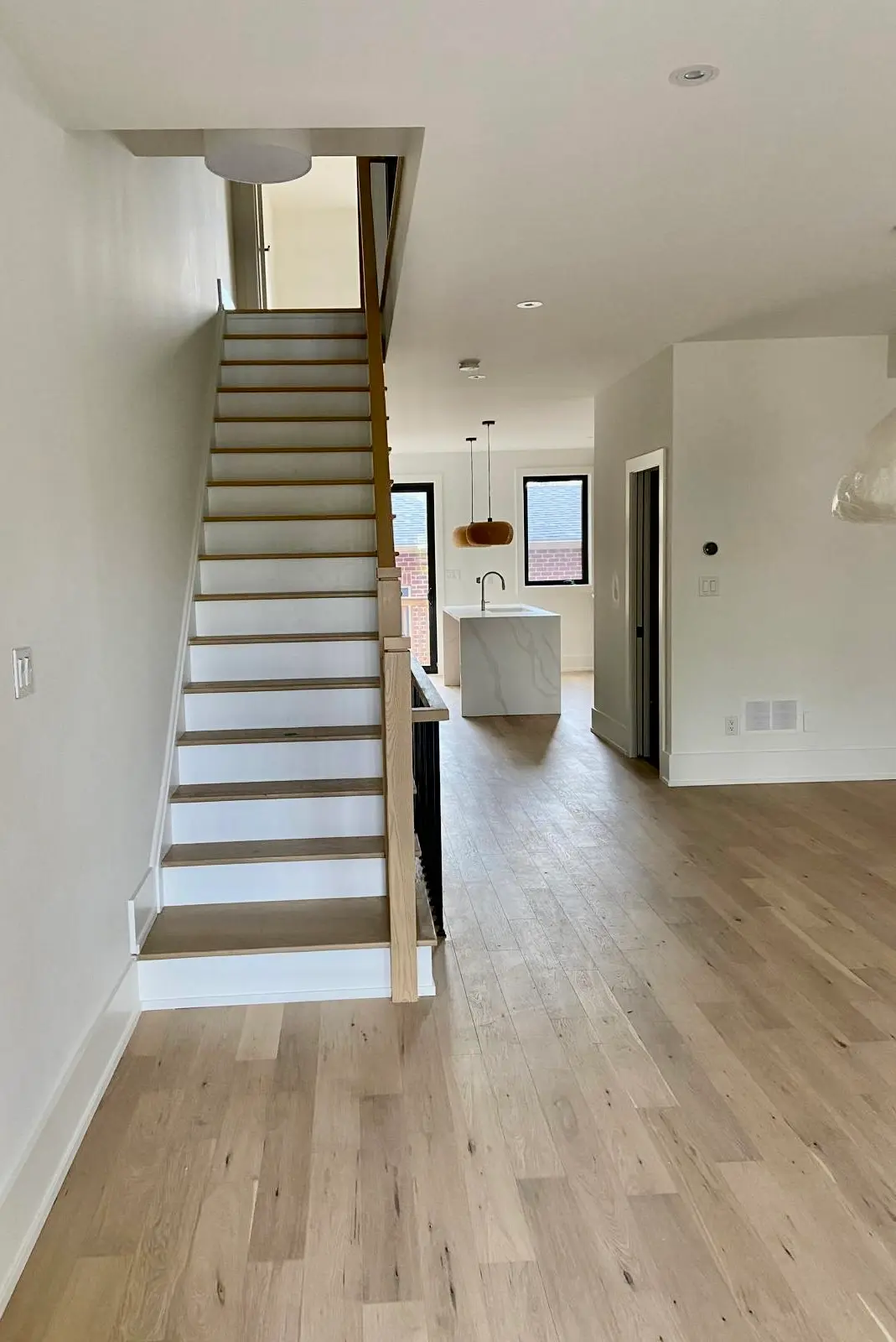 Open plan staircase with light oak flooring