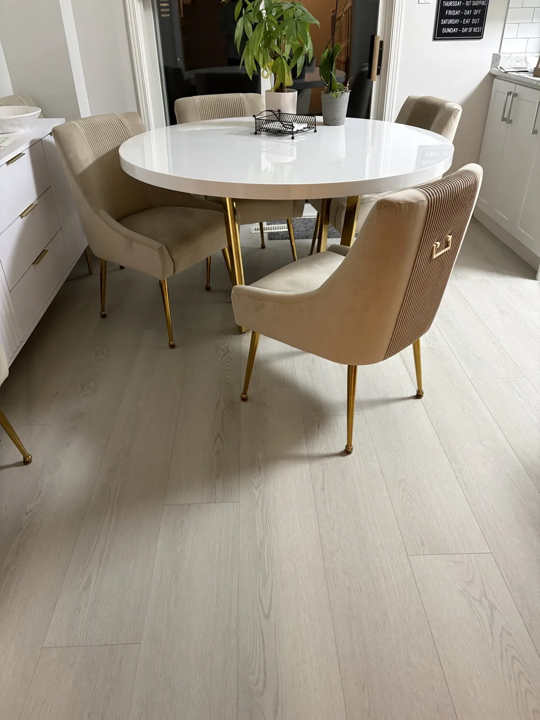 Pale whitewashed wide-plank flooring in a dining area