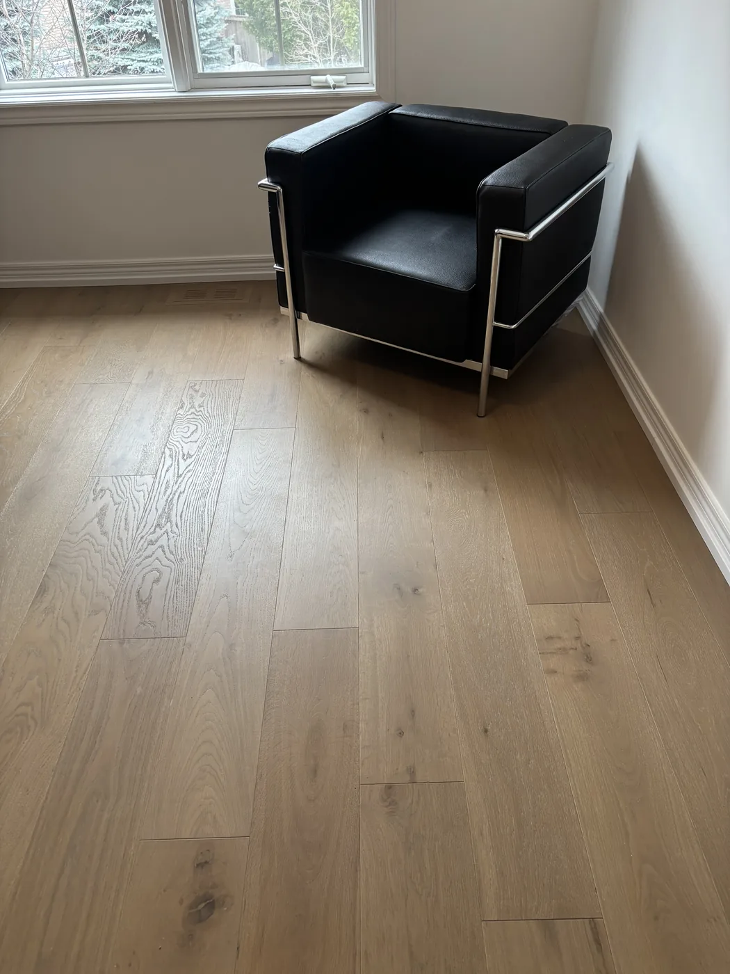 Wide-plank oak flooring in a living room with natural light